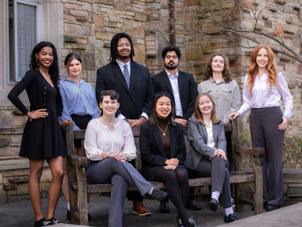 group image of Rhodes College students standing and sitting outside a campus building